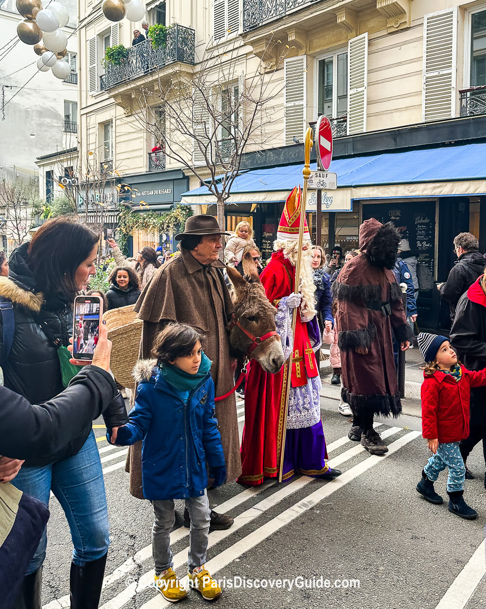 Saint Nicolas and his donkey arrive on Rue des Martyrs