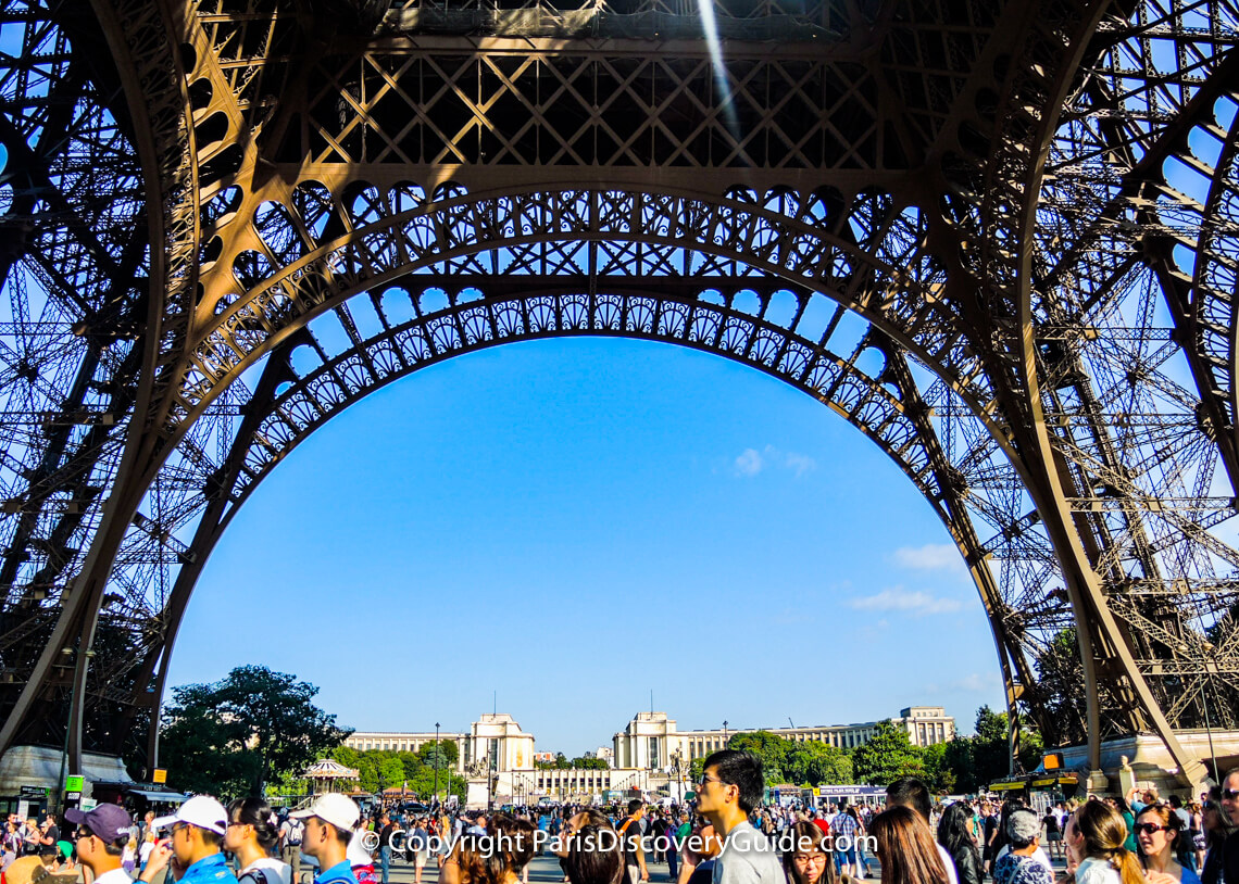 During summer months, crowds waiting in Eiffel Tower ticket lines fill all the space around the "Iron Lady"
