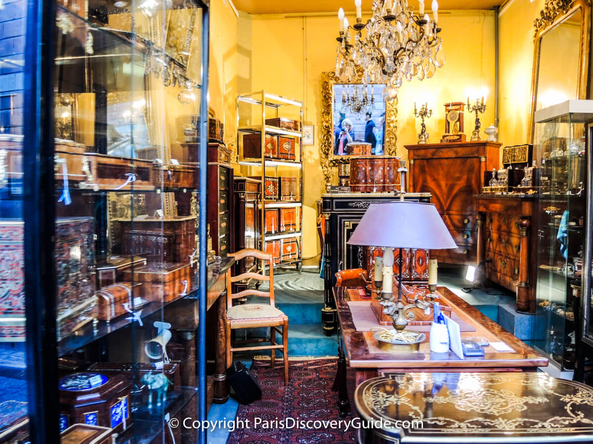 Inlaid boxes and fine furniture in antiques showroom at Paris Flea Market Inlaid boxes and fine furniture in antiques showroom at Paris Flea Market