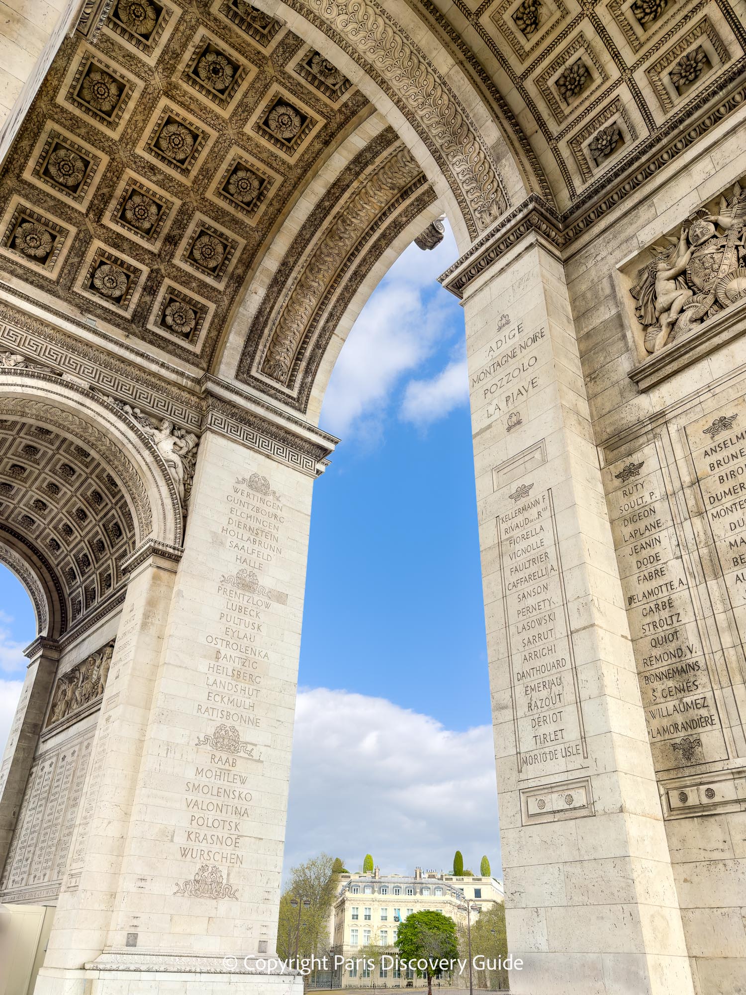 Close-up look at the names inscribed on the Arc de Triomphe - for example on the pillar on the left, you can see names of battles separated by laurel wreaths