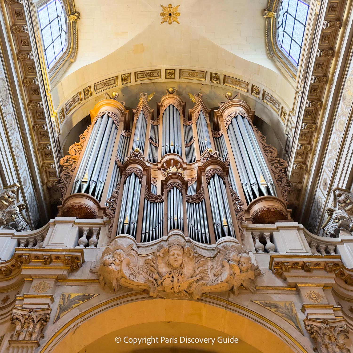 Close-up view of the organ's pipes and the sculpted angels