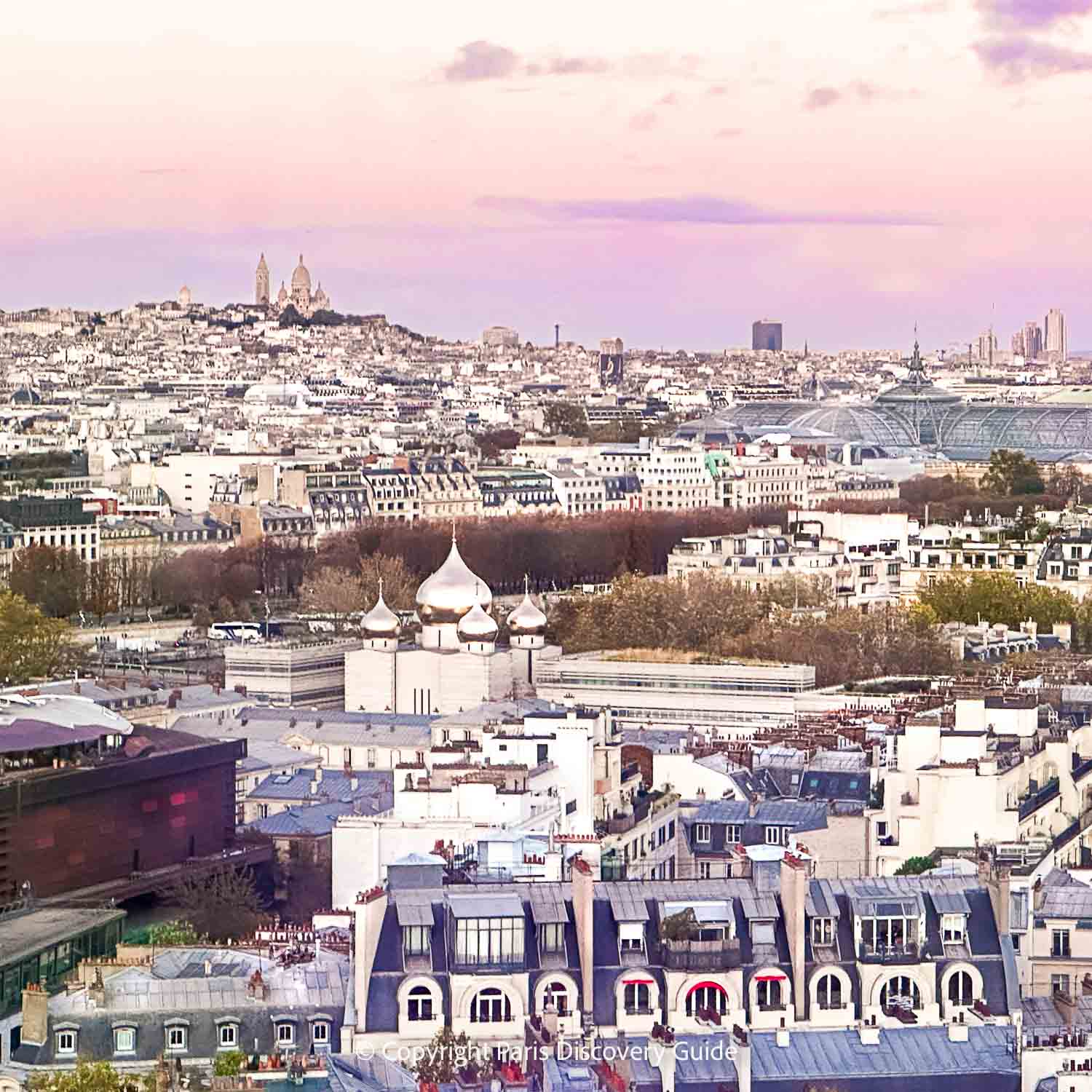 Paris skyline seen from the Eiffel Tower's Second Level observation deck, with Pont Debilly bridge and other nearby attractions easy to spot and Sacre Coeur and Montmartre visible on the skyline