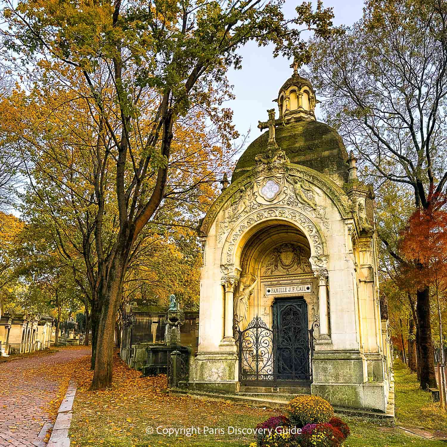 Chrysanthemums in front of a grave at Pere Lachaise Cemetery on All-Saints Day