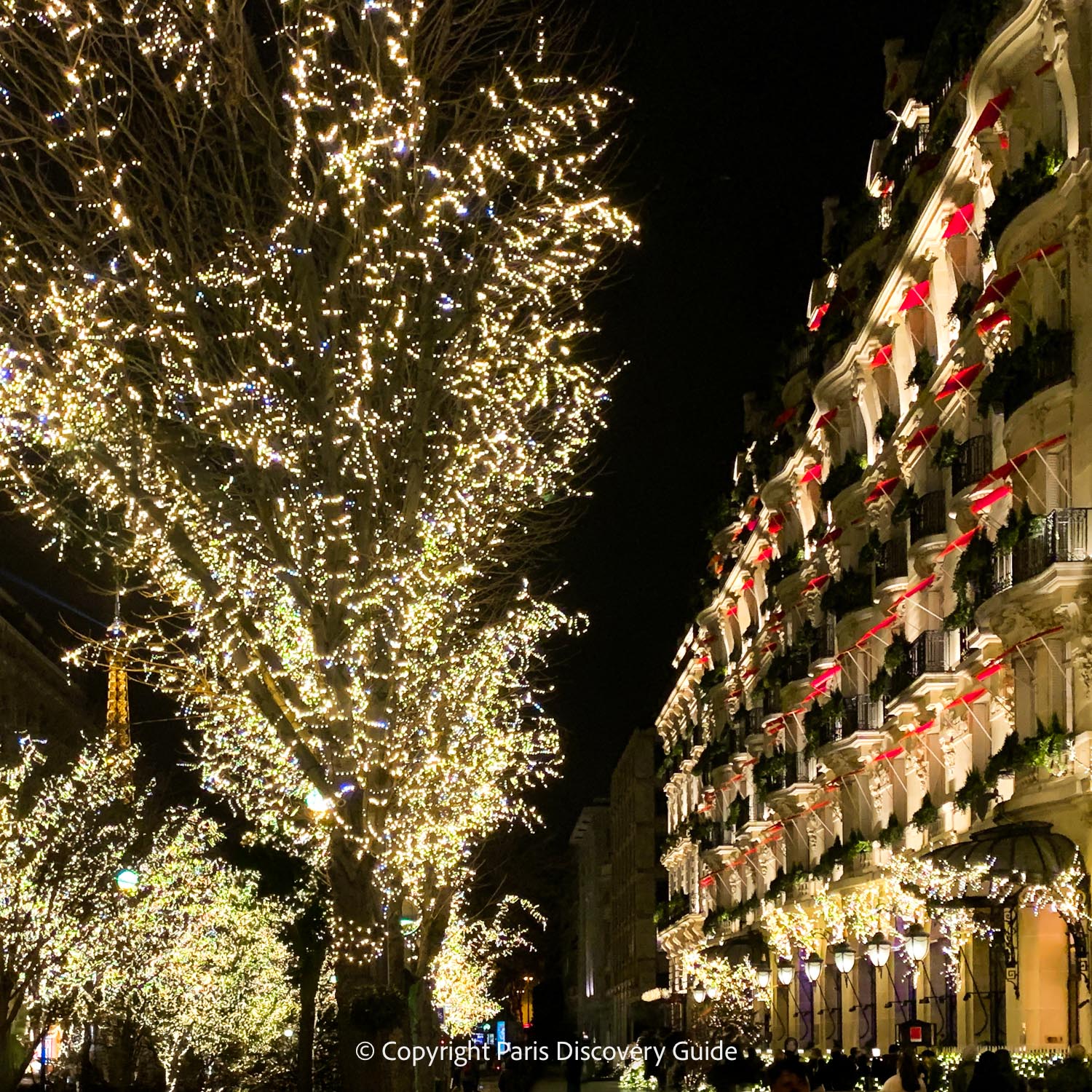 Le Plaza Athénée with Christmas lights along Avenue Montaigne and Eiffel Tower views