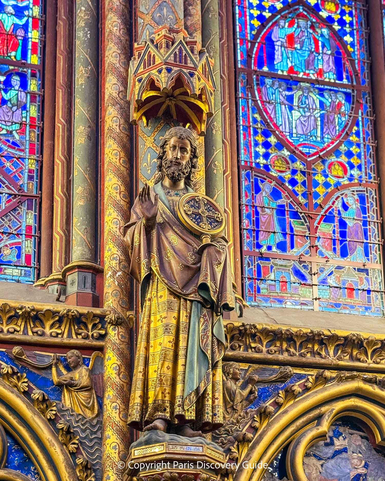 Close-up view of stained glass windows and sculptural details at Sainte-Chapelle