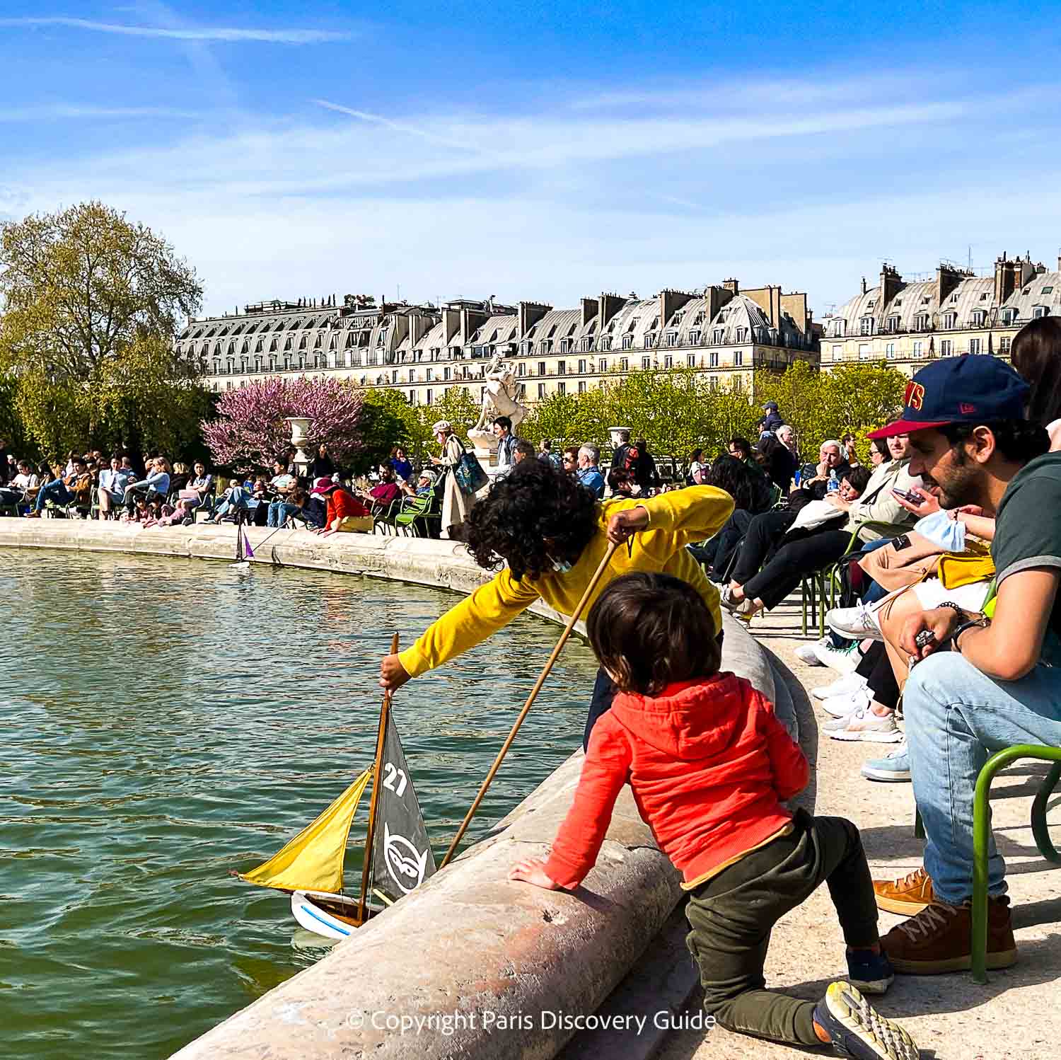 Sailing a boat at Tuileries Garden