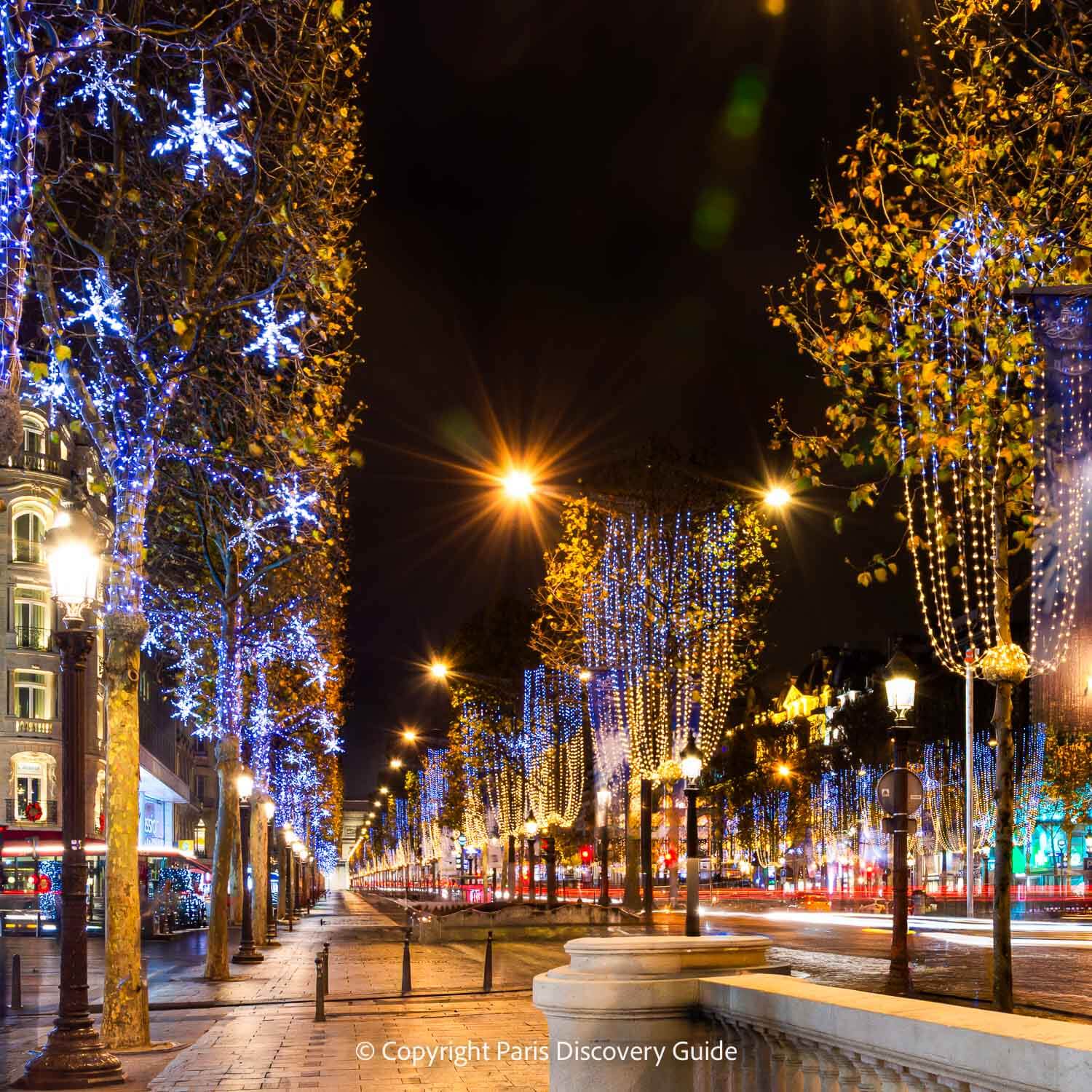 Christmas lights along Champs-Elysees, with a glimpse of the Arc de Triomphe in the background