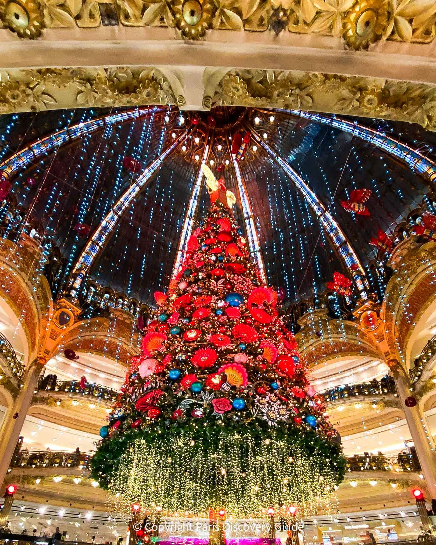 Festive Christmas tree suspended from the ceiling at Galeries Lafayette