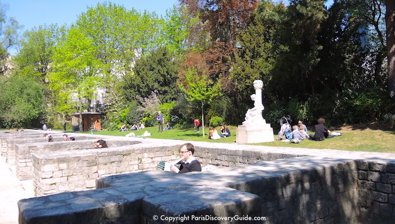 Grassy picnic area and seating alcoves along the stage of Arènes de Lutèce in Paris Grassy picnic area and seating alcoves along the stage of Arènes de Lutèce in Paris