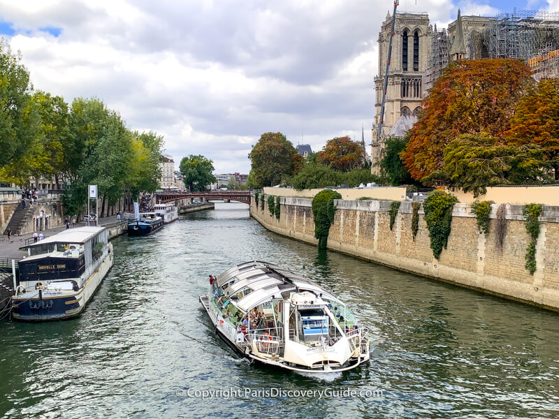 Seine River cruise boat as it passes Notre Dame