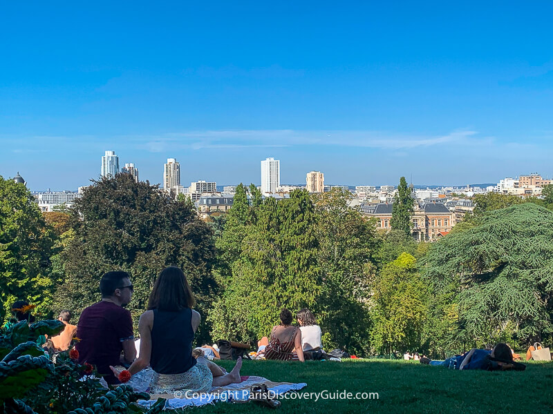Can you spot the Eiffel Tower along the Paris skyline in this photo from Parc Buttes-Chaumont?