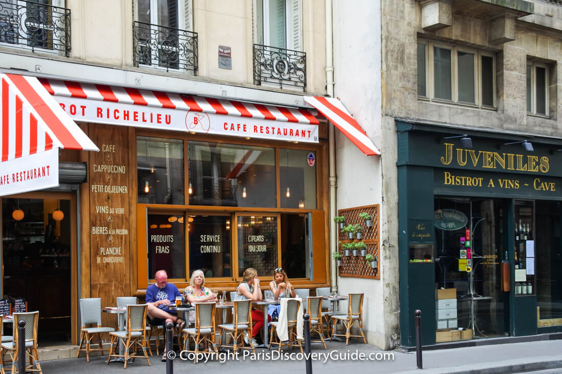 Cafe on Rue Richelieu near Palais Royal in the 1st arrondissement; Juveniles, next door, is a popular wine bar Cafe on Rue Richelieu near Palais Royal in the 1st arrondissement; Juveniles, next door, is a popular wine bar