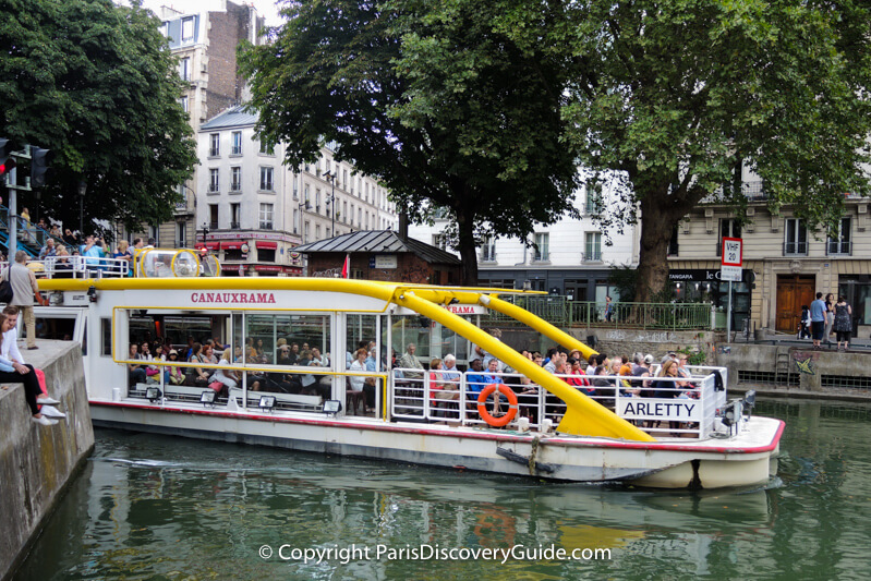 Cruise boat in Canal Saint-Martin as it heads toward Bassin de la Villette