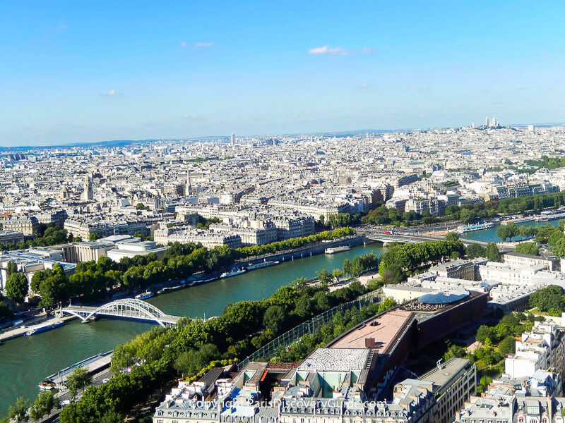 Paris skyline seen from the Eiffel Tower's Second Level observation deck, with Pont Debilly bridge and other nearby attractions easy to spot and Sacre Coeur and Montmartre visible on the skyline