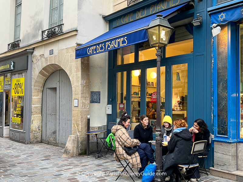 Outdoor dining on a partly-cloudy (and slightly sunny) cold January afternoon on Rue des Rosiers in the Marais