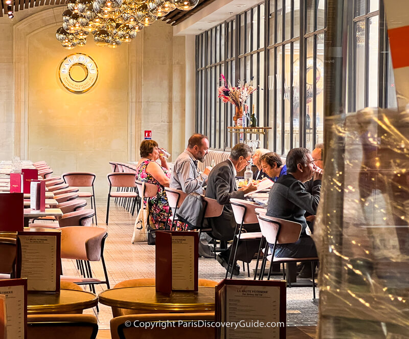 Diners in Dalloyau's covered footbridge seating area