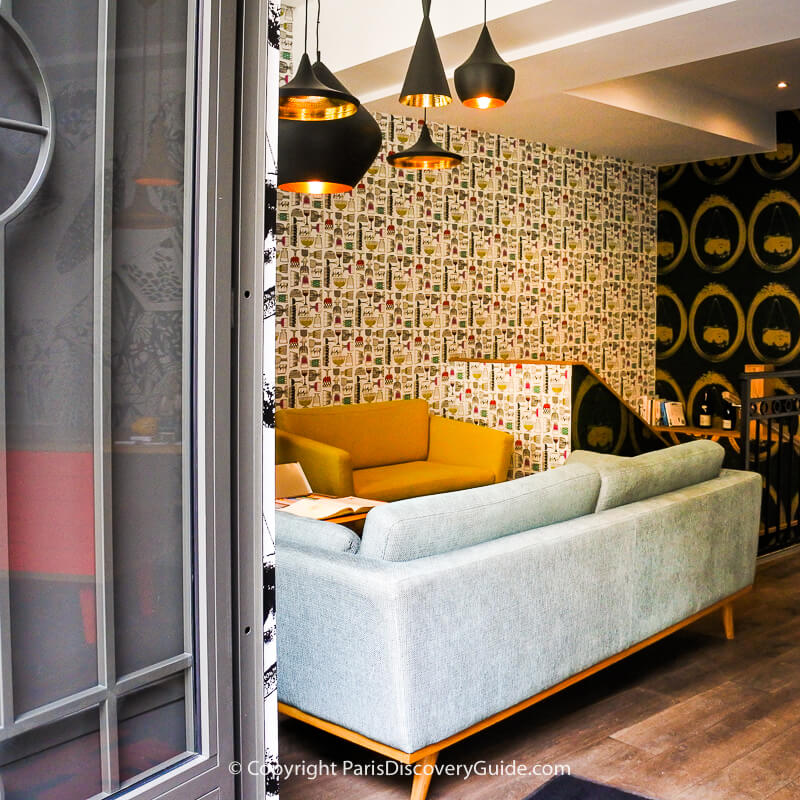 Vibrant graphic design meets mid-century furnishings in the chic Hôtel Crayon lobby in Paris's 1st Arrondissement