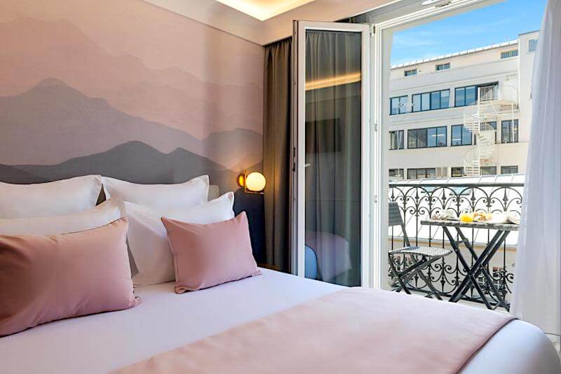 Guest room with balcony at Hotel Le Milie Rose in Paris's 10th arrondissement