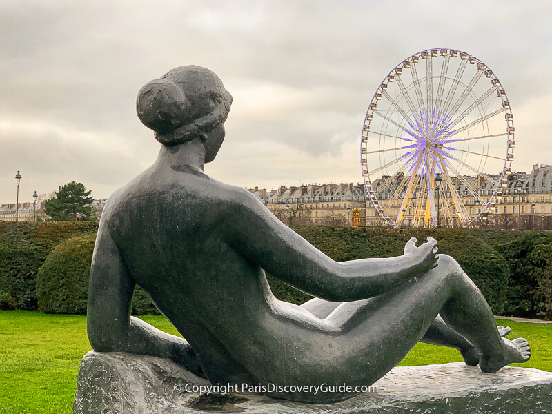 Malliol statue overlooking the seasonal ferris wheel in Jardin des Tuileries Malliol statue overlooking the seasonal ferris wheel in Jardin des Tuileries