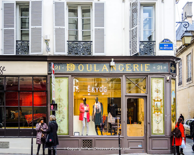 Shoppers by boutiques in Paris's Marais neighborhood  