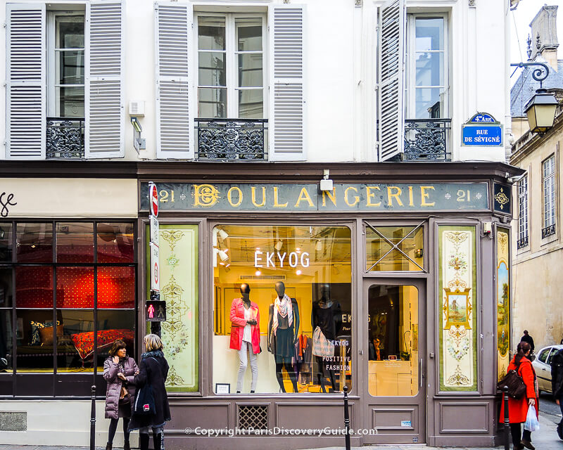 Shoppers by boutiques in Paris's Marais neighborhood Shoppers by boutiques in Paris's Marais neighborhood