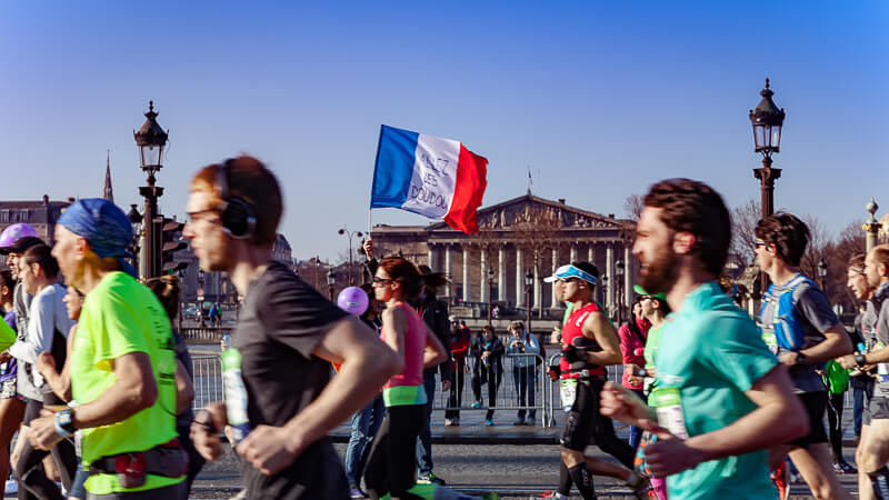 Paris Marathon runners with Assemblée Nationale in the background - Photo credit: istockphoto.com/onickzartworks