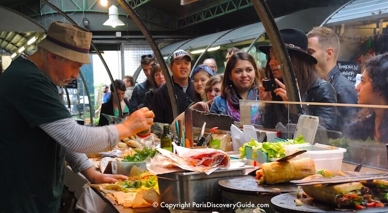 Gourmet sandwiches being prepared at Marché des Enfants Rouges