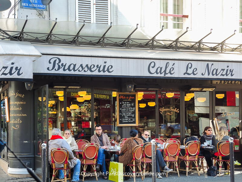 Outdoor dining on a partly-cloudy (and slightly sunny) cold February afternoon on Rue des Rosiers in the Marais