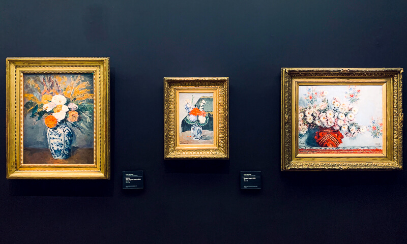 Still lifes of flowers in vases painted by Cezanne (the two on the left) and Monet (right)