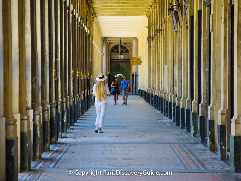 Covered shopping arcade at Palais Royal - to the left is a sculpture-filled inner courtyard and spectacular garden, and on the right, hidden from view in this photo, are small specialty boutiques Covered shopping arcade at Palais Royal - to the left is a sculpture-filled inner courtyard and spectacular garden, and on the right, hidden from view in this photo, are small specialty boutiques