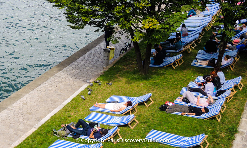 Relaxing on a grassy Paris "beach" overlooking the Seine River