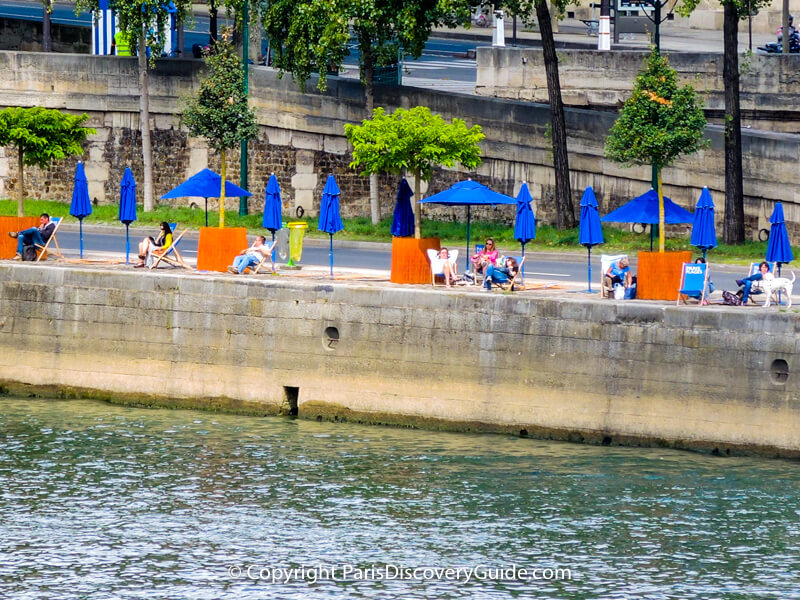 Beach chairs and umbrellas on the Right Bank of the Seine Beach chairs and umbrellas on the Right Bank of the Seine