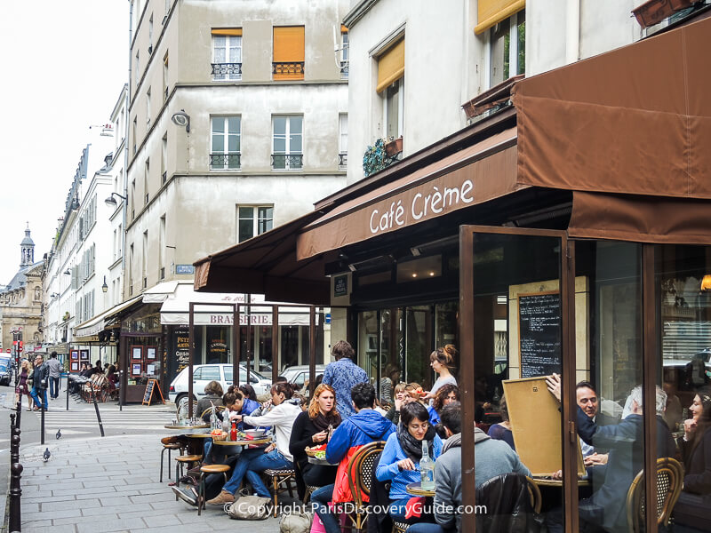 Outdoor diners at a cafe in the Upper Marais