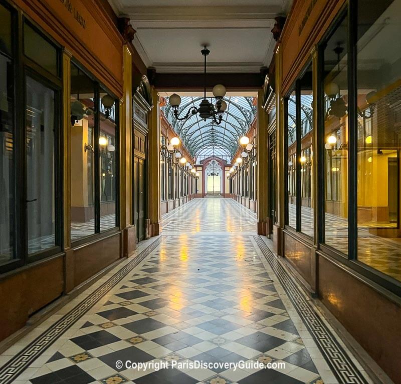 Passage des Princes in 2022, photographed through locked iron gates barring the Rue de Richelieu entrance Passage des Princes in 2022, photographed through locked iron gates barring the Rue de Richelieu entrance
