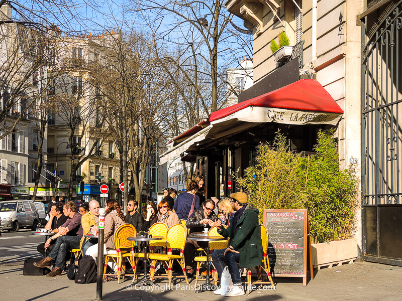 Outdoor seating at Cafe La Factorie Saint Amour next to Pere Lachaise Cemetery in early March