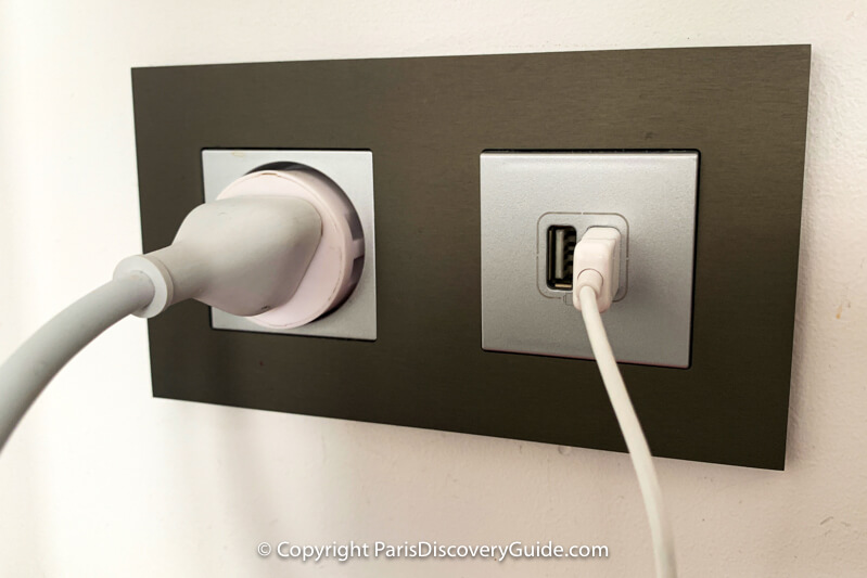 Type E socket (with an adapter and plug in it) and USB port combination outlet