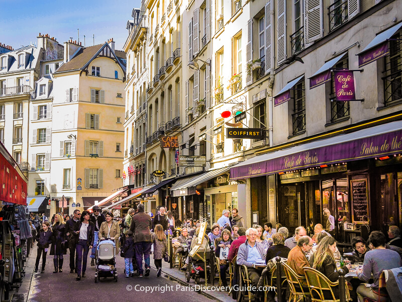 Outdoor tables Rue Buci in Paris's 6th arrondissement in early April