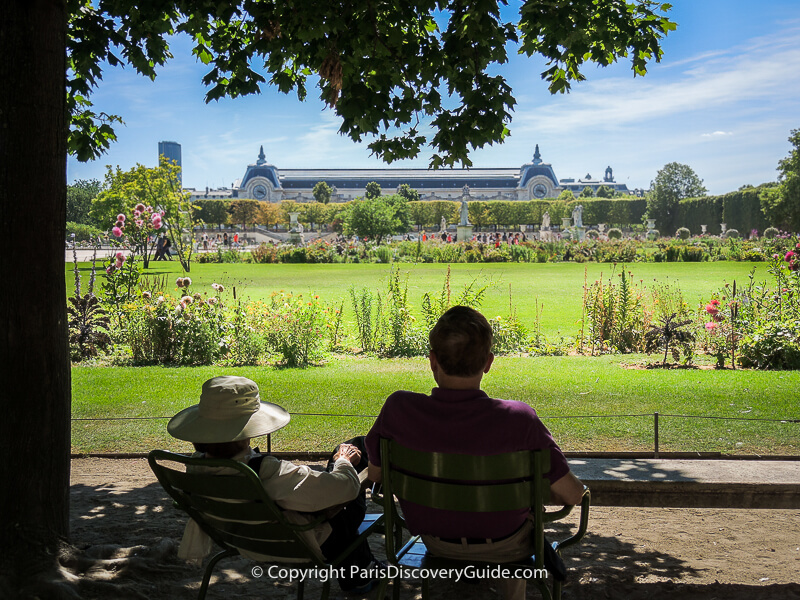 Couple sitting in the shade in Tuileries Garden during a very hot July afternoon in Paris