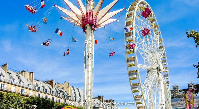 Giant ferris wheel and thrill ride at Tuileries Garden Carnival Giant ferris wheel and thrill ride at Tuileries Garden Carnival