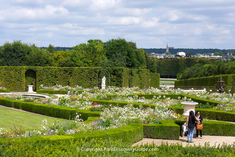 Formal garden at Versailles, with distant view of town of Versailles Formal garden at Versailles, with distant view of town of Versailles