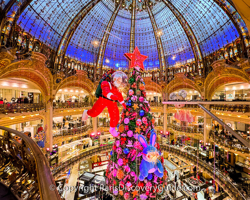 A giant candy tree floats from Galeries Lafayette's domed ceiling