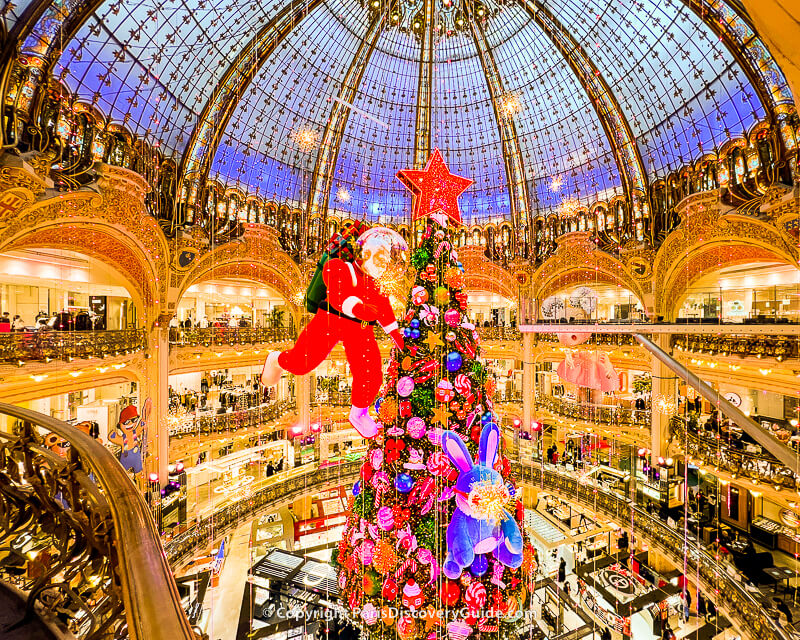 Christmas decorations and lights suspsended from the skylight dome in Galeries Lafayette