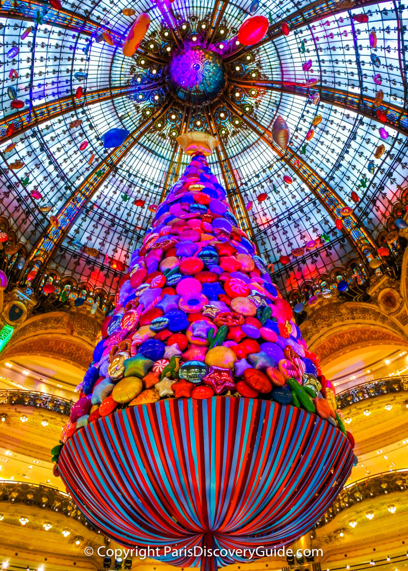 A giant candy tree floats from Galeries Lafayette's domed ceiling