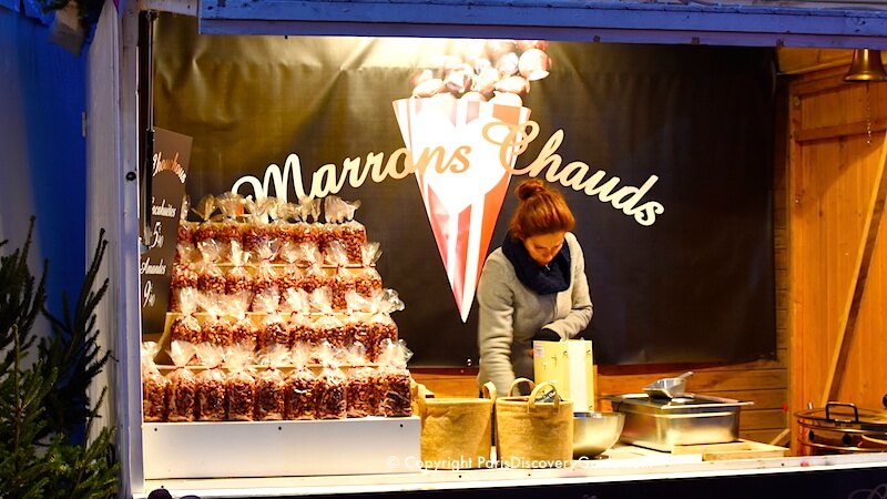 Paris Christmas Market at Saint-Germain-des-Pres - hot roasted chestnuts Paris Christmas Market at Saint-Germain-des-Pres - hot roasted chestnuts