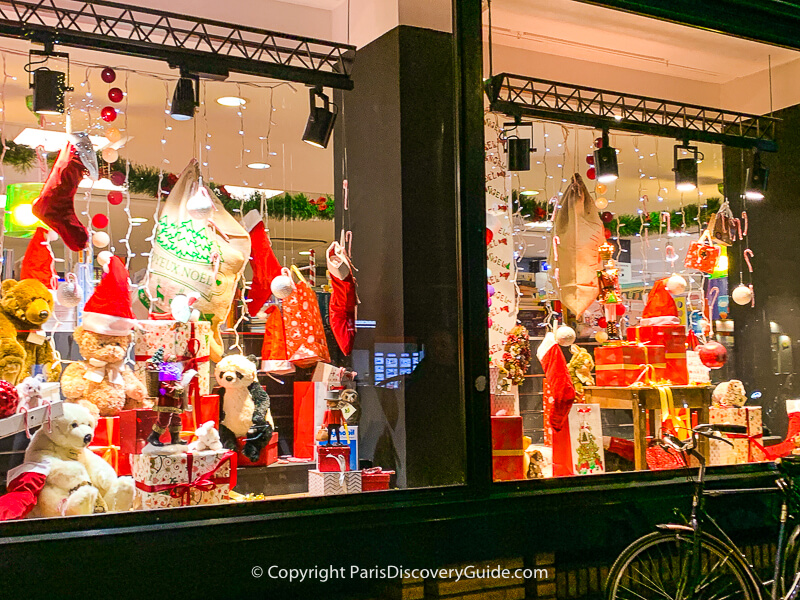 Toys and Christmas stockings in this holiday window display on Boulevard Saint-Germain