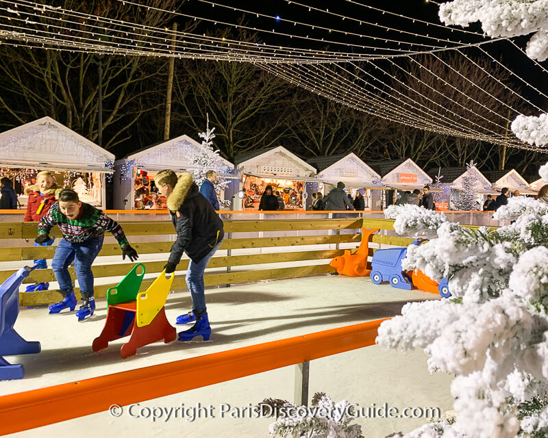 Ice rink and skaters at Tuileries Garden Christmas Market Ice rink and skaters at Tuileries Garden Christmas Market