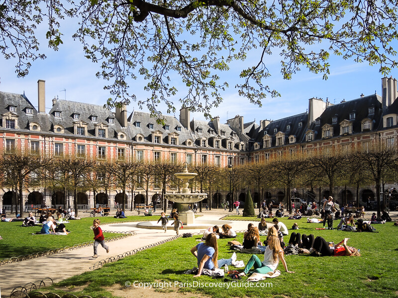 Place des Vosges in the Marais on a mostly sunny day in early April