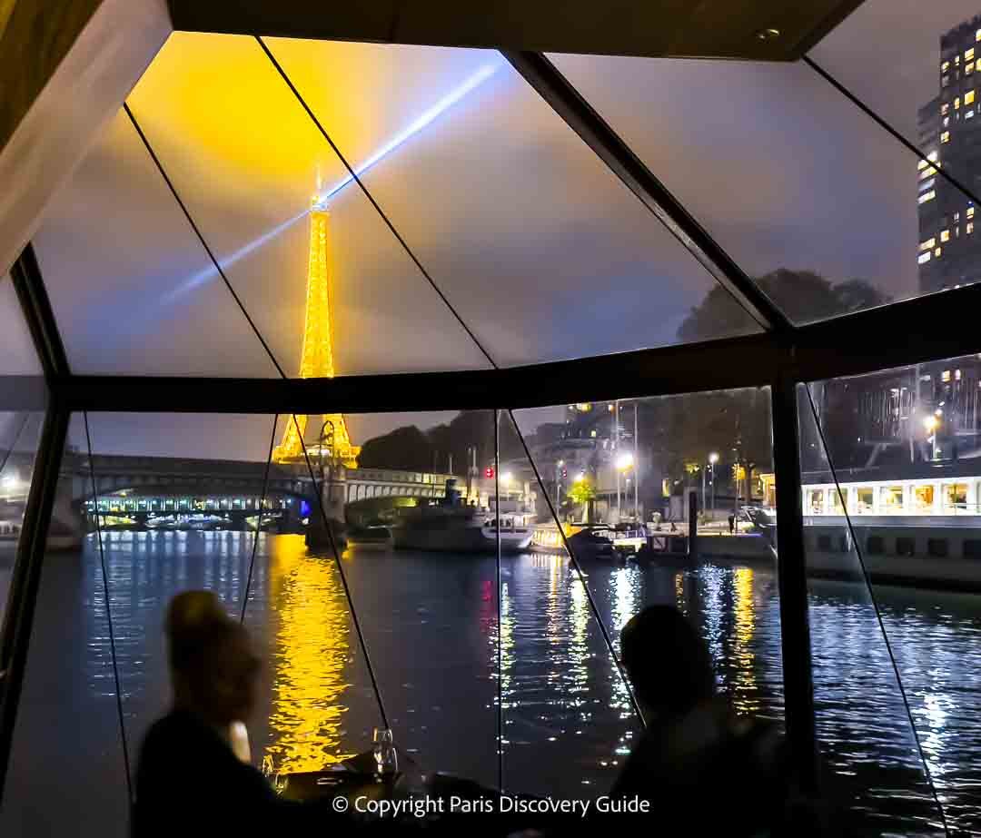 View of the Eiffel Tower from the front of a Seine River dinner cruise on a Bateau Mouches boat View of the Eiffel Tower from the front of a Seine River dinner cruise on a Bateau Mouches boat