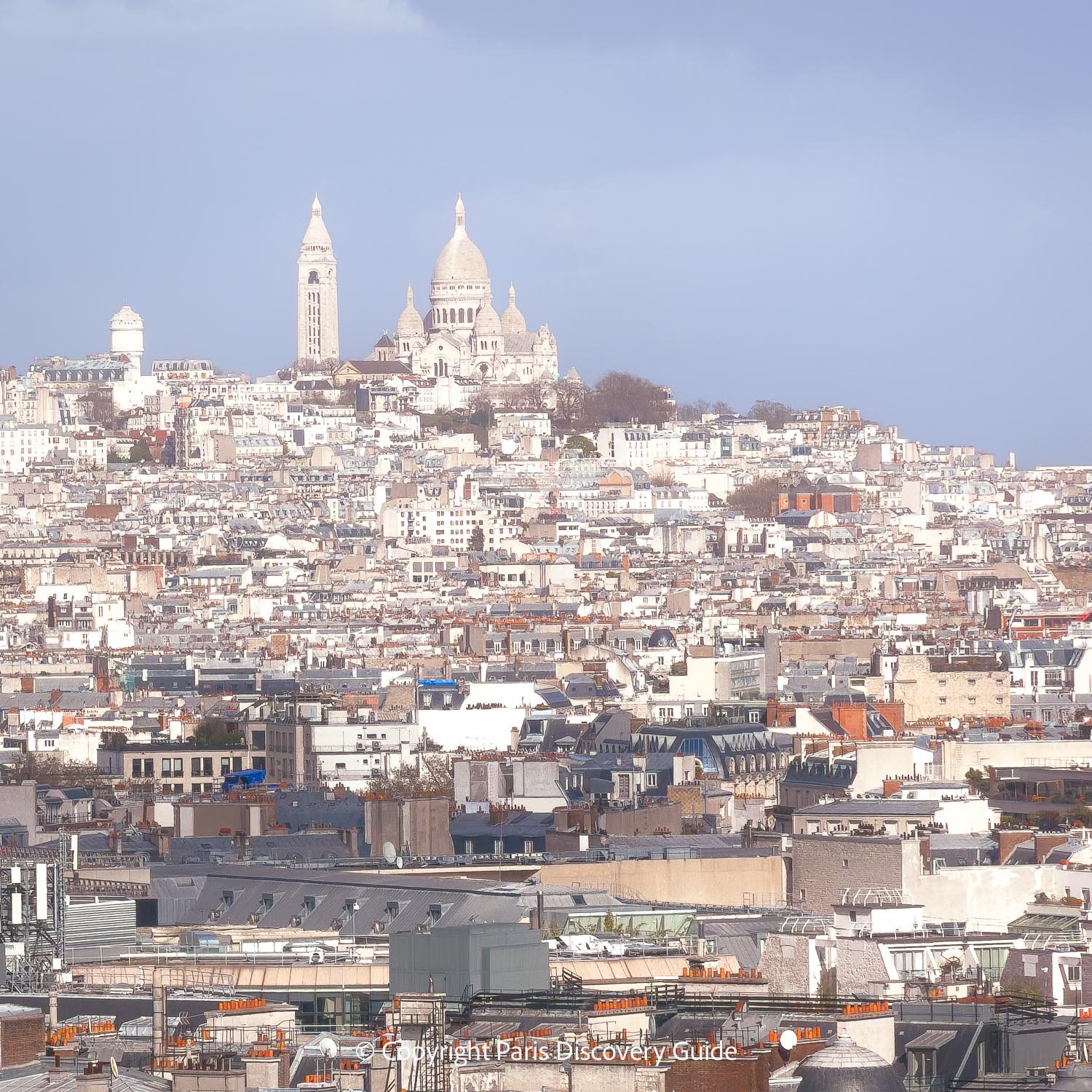 TSacre Coeur Basilica on top of Montmartre's highest hill, which you can see from the Arc's rooftop