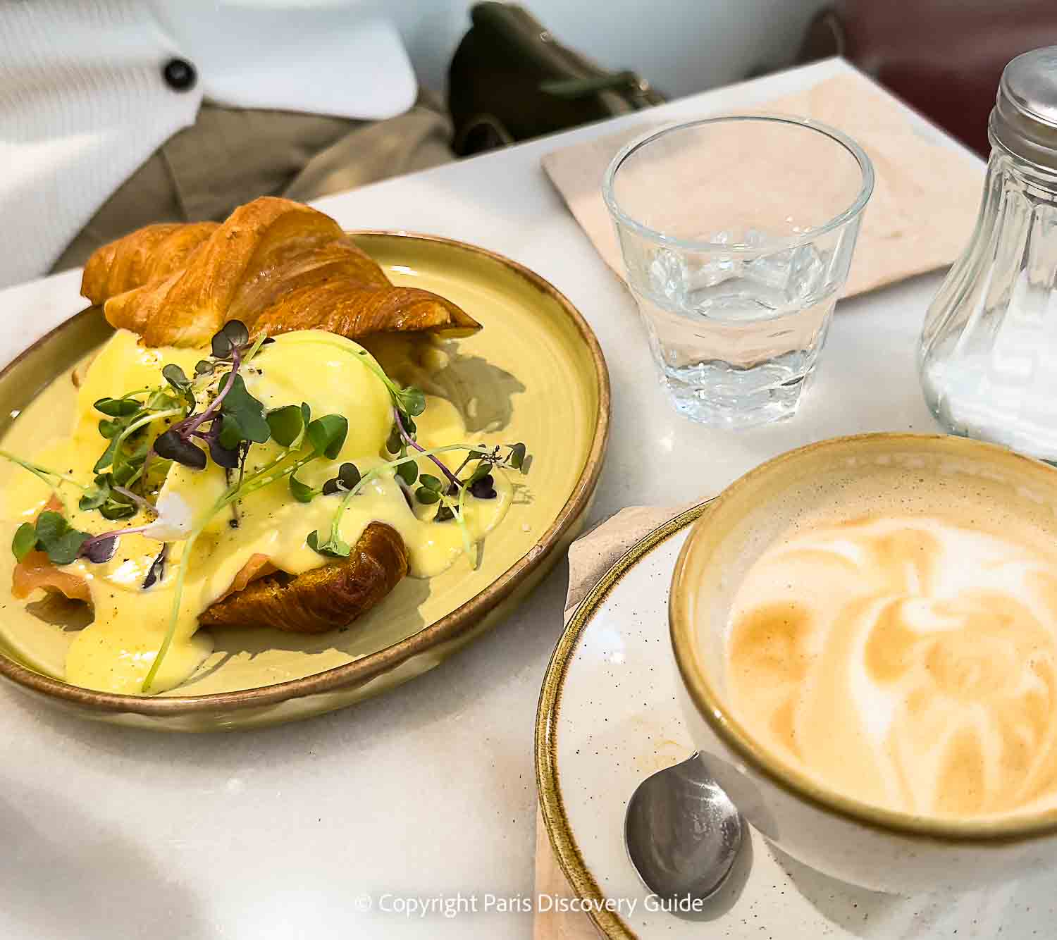 Smoked salmon and eggs benedict on a croissant at Sunday brunch at the trendy Inform Café/Coffee Shop at Citéco, Paris's entertaining new economics museum (the first in Europe) in the 17th arrondissement Smoked salmon and eggs benedict on a croissant at Sunday brunch at the trendy Inform Café/Coffee Shop at Citéco, Paris's entertaining new economics museum (the first in Europe) in the 17th arrondissement